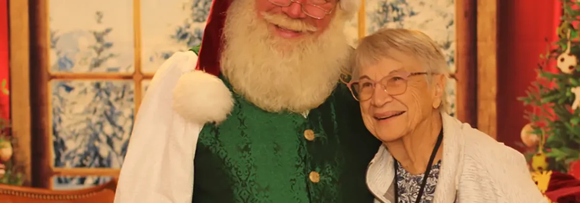 Photo of a senior resident with Santa