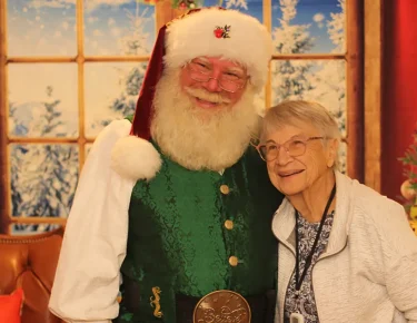 Photo of a senior resident with Santa