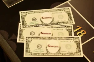 Three $500 bills marked "Summerset" are placed on a black surface next to a gold number 18, hinting at the high stakes and excitement of Casino Night.